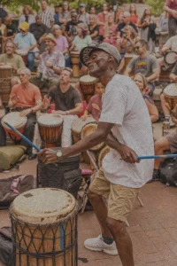 a man drumming at Pritchard Park