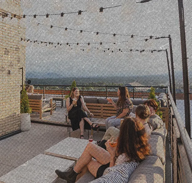 people having drinks at the rooftop bar at the Flat Iron Hotel