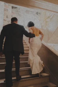 a couple going up the stairs at the Flat Iron Hotel