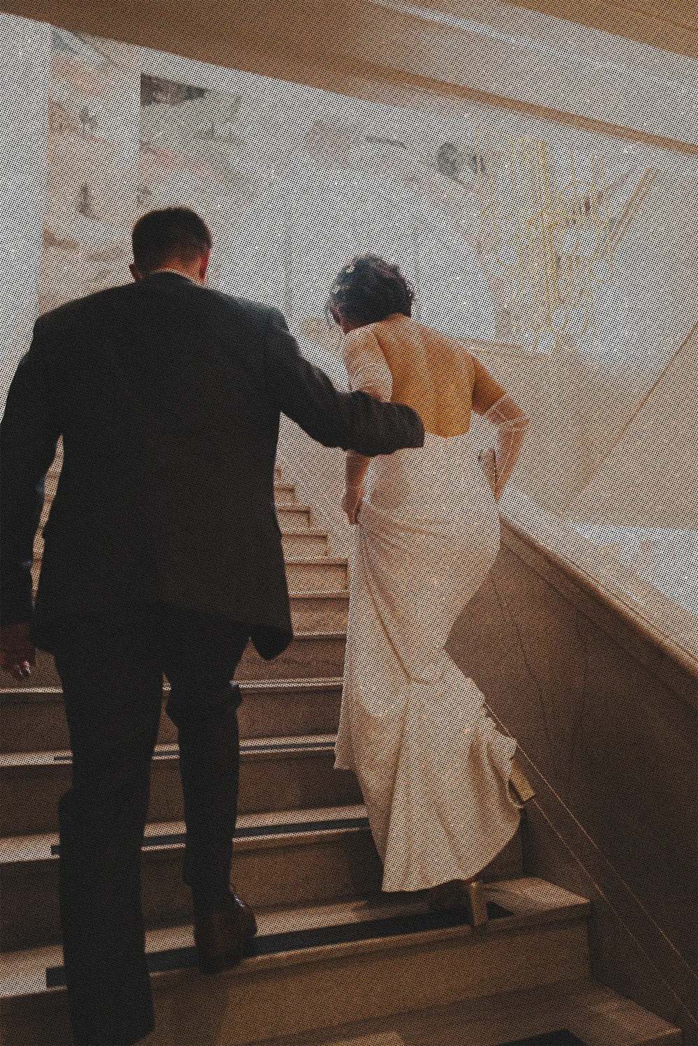 a couple going up the stairs at the Flat Iron Hotel