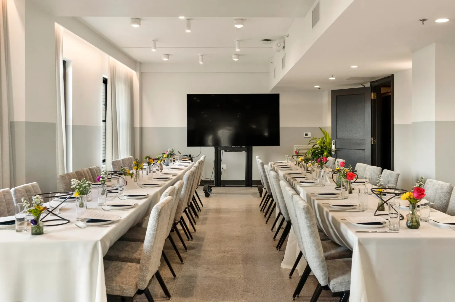 banquet tables set for a private dinner in the iron works lounge