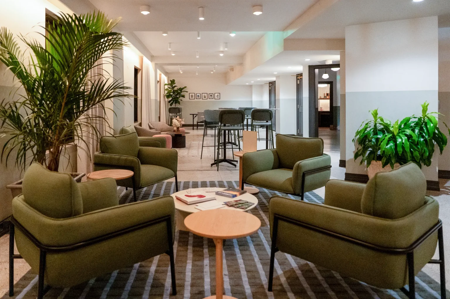 chairs and tabled arranged throughout the iron works lounge at night
