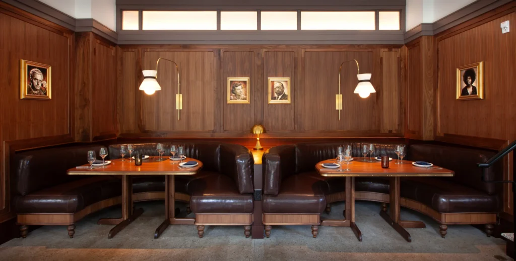 a suite of banquettes in luminosa, with paintings of Asheville celebrities