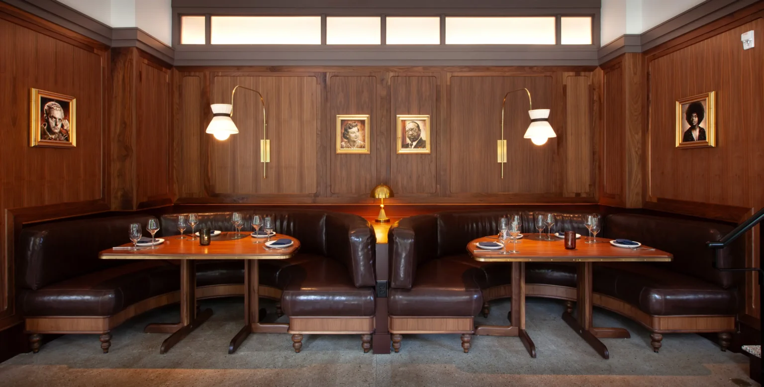 a suite of banquettes in luminosa, with paintings of Asheville celebrities