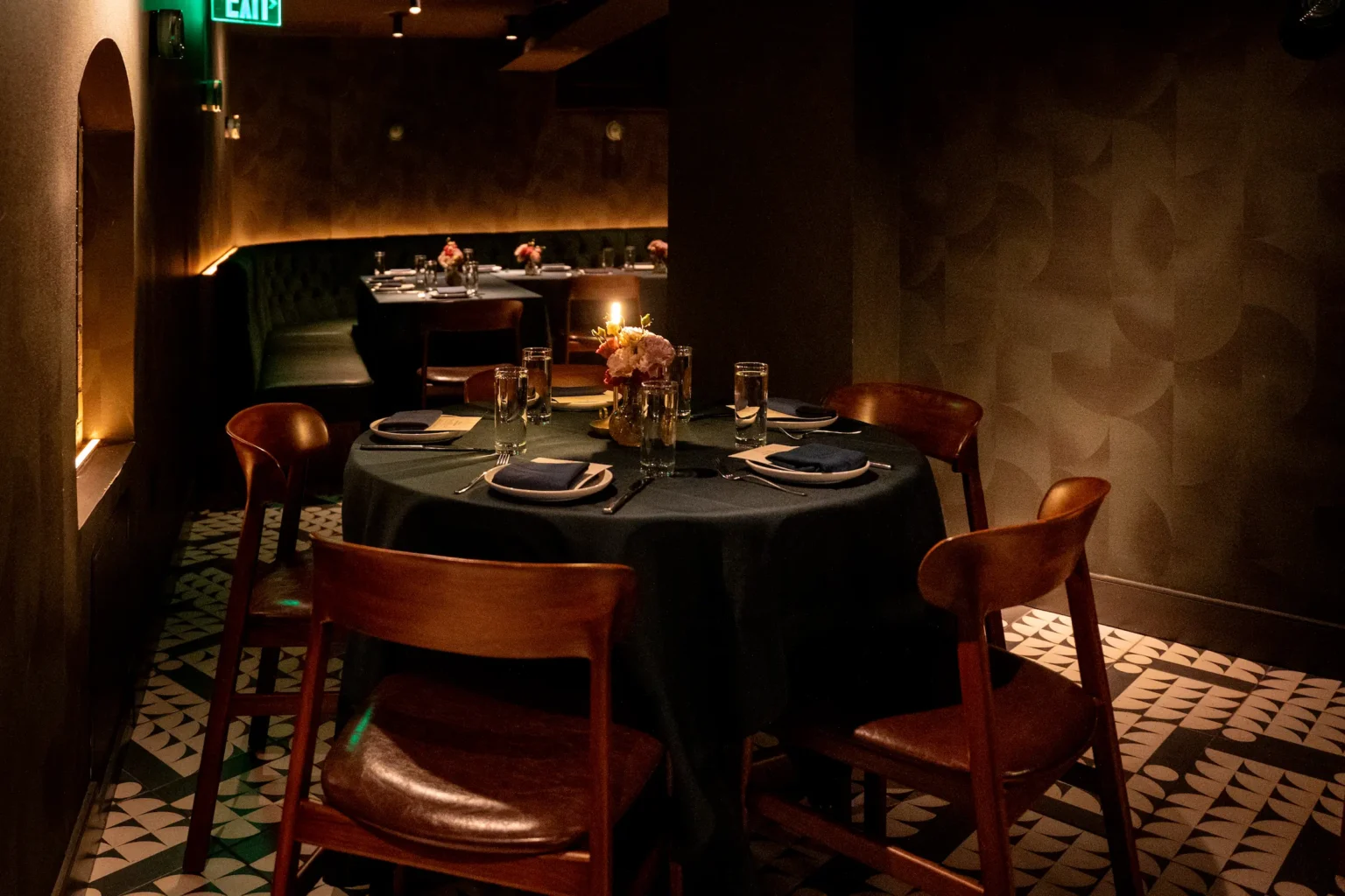 an intimate table set for a moody private dinner in red ribbon society