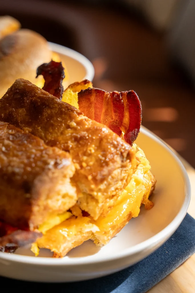 a breakfast sandwich with bacon from the rooftop caffe at the flat iron hotel