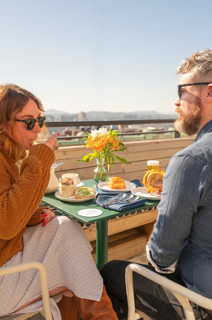 a couple having breakfast at the rooftop caffe at the flat iron hotel