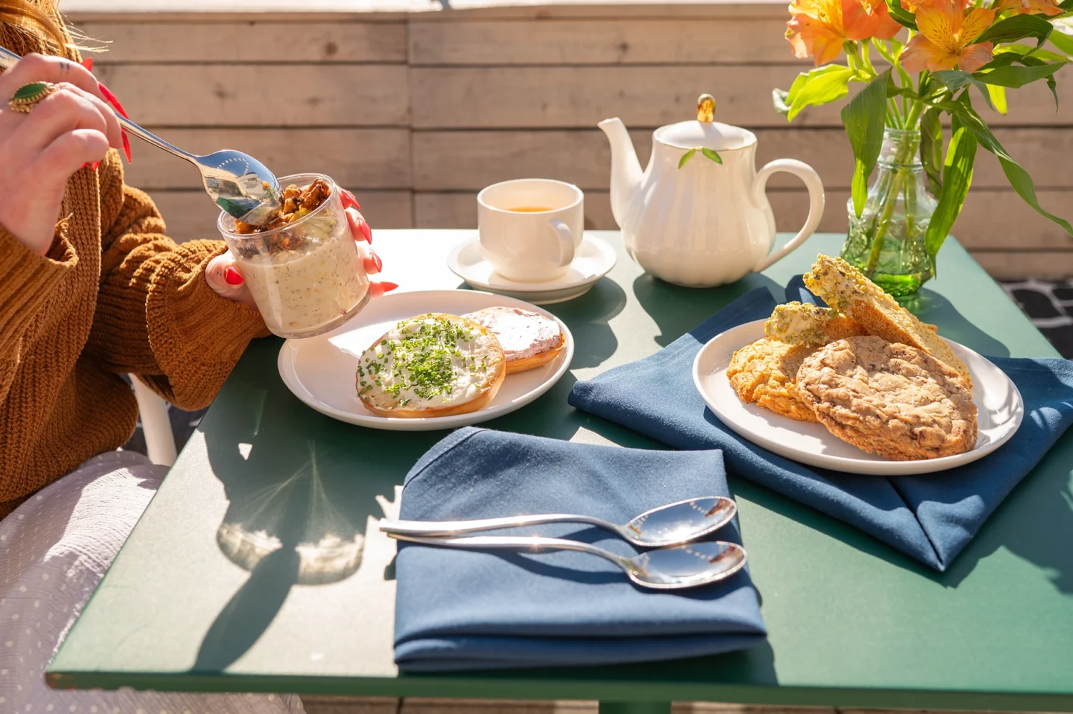 a woman enjoys breakfast on a rooftop