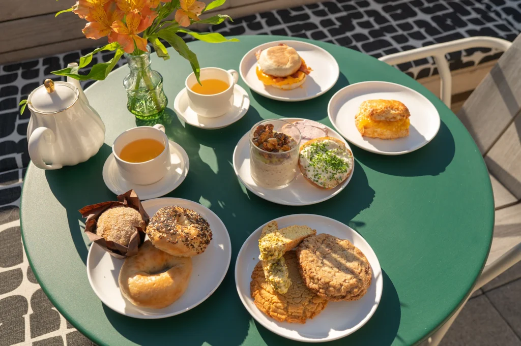 a variety of breakfast treats from the rooftop caffe in the sunlight, at the flat iron hotel