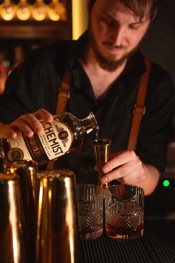 bartender pouring whiskey