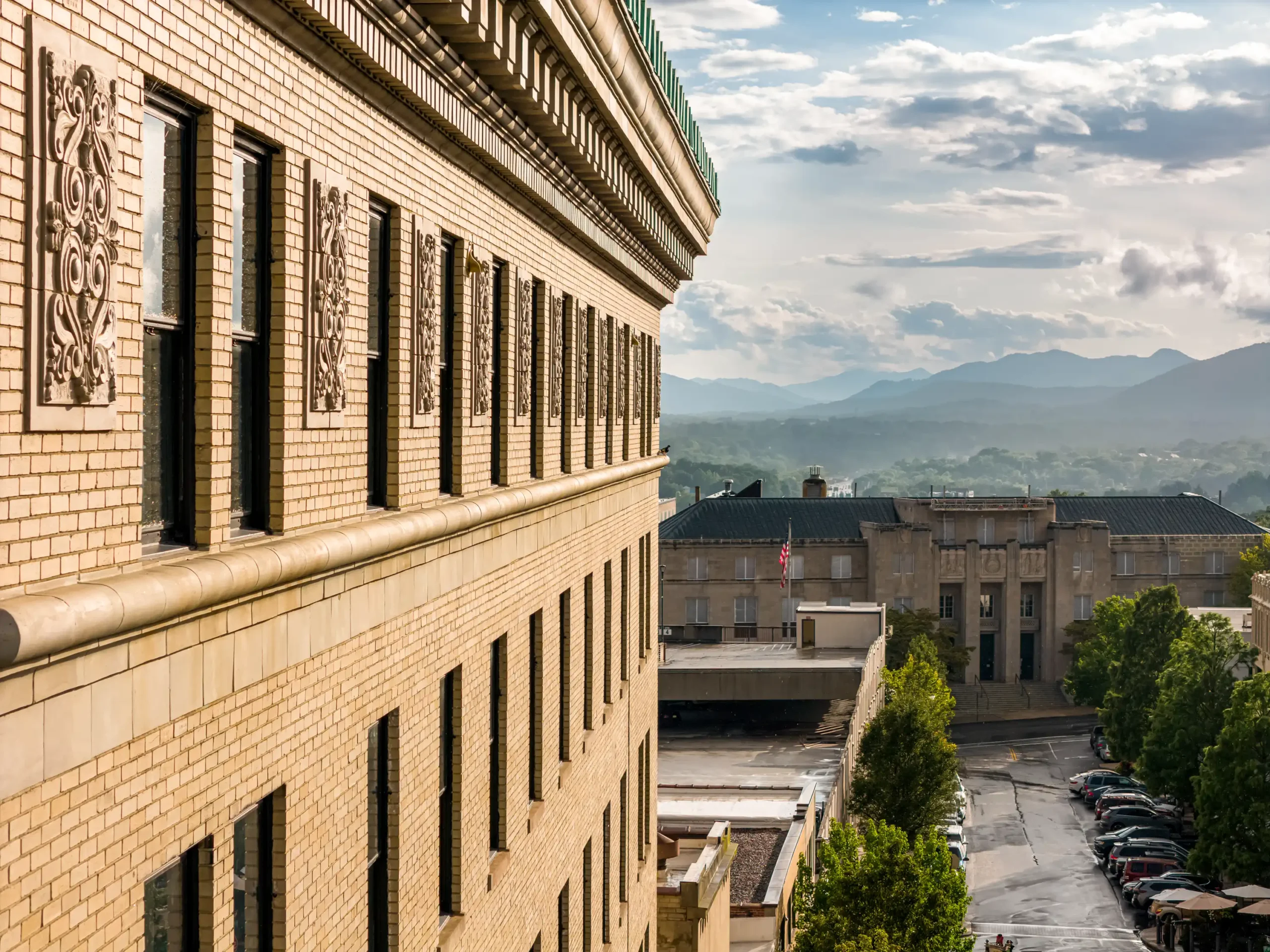 facade of the flat iron hotel and a mountain view