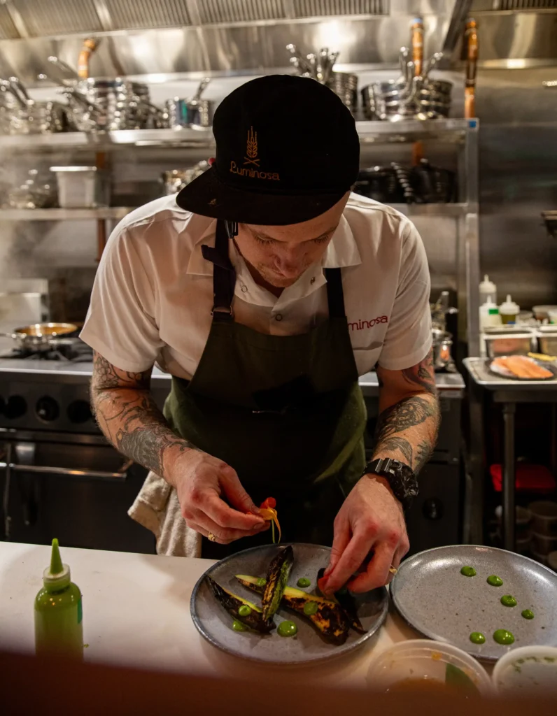 the chef preparing a masterpiece at luminosa in the flat iron hotel