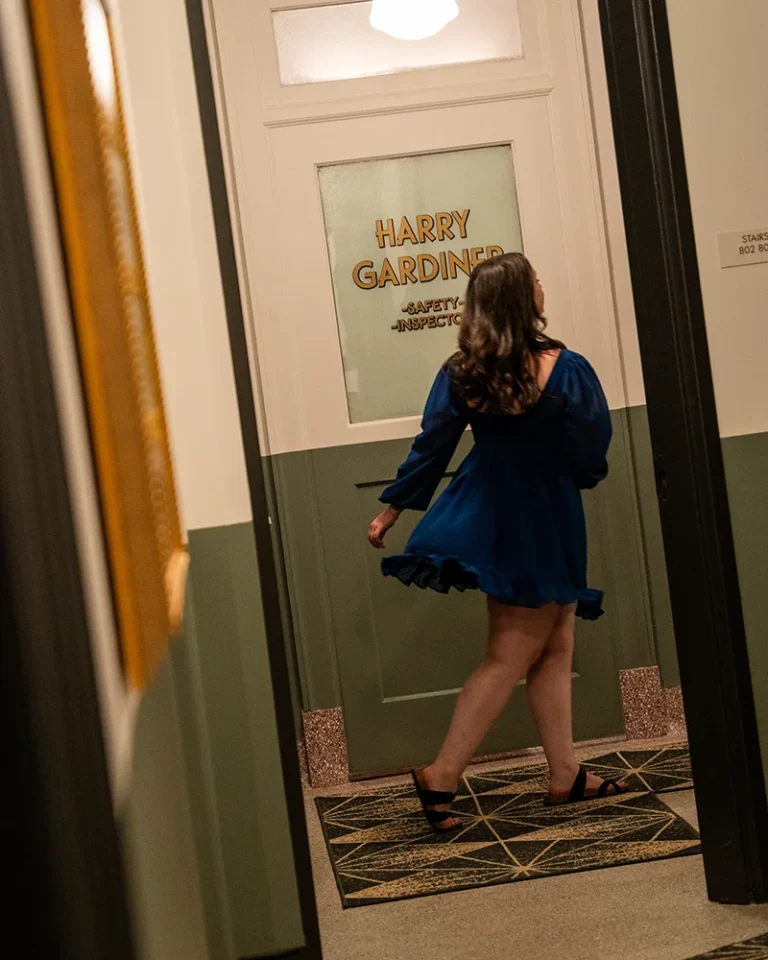 a woman walks past historic office signs