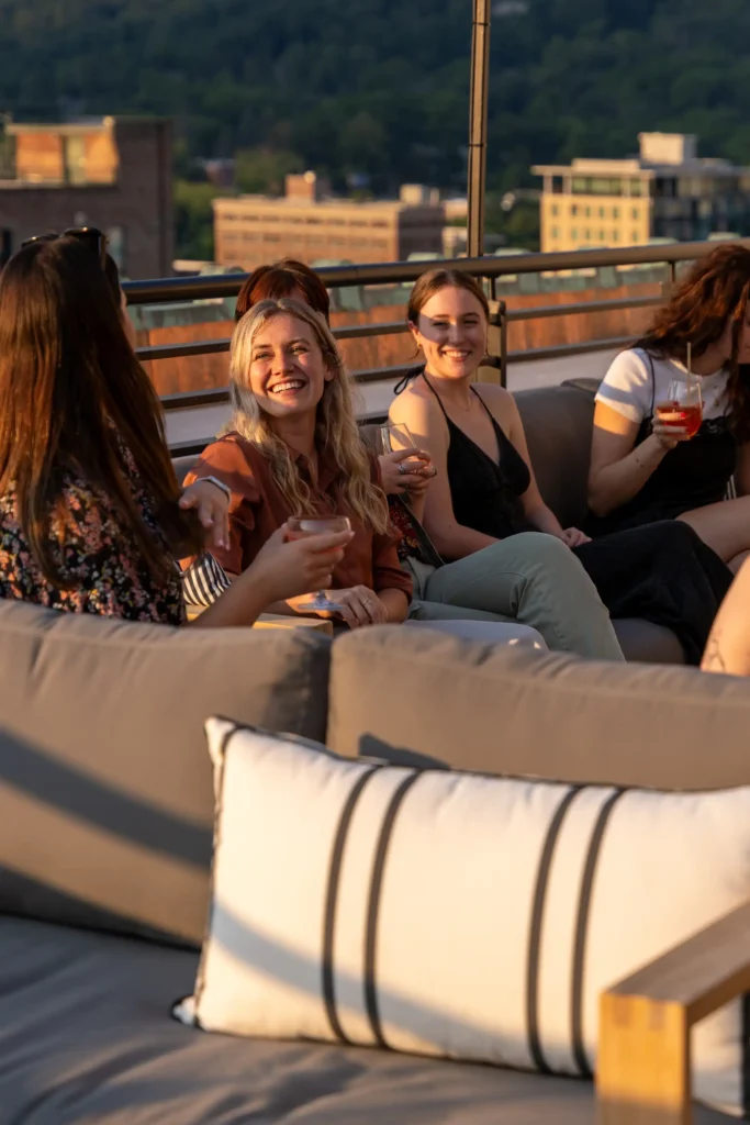 people having drinks at the roof top bar patio