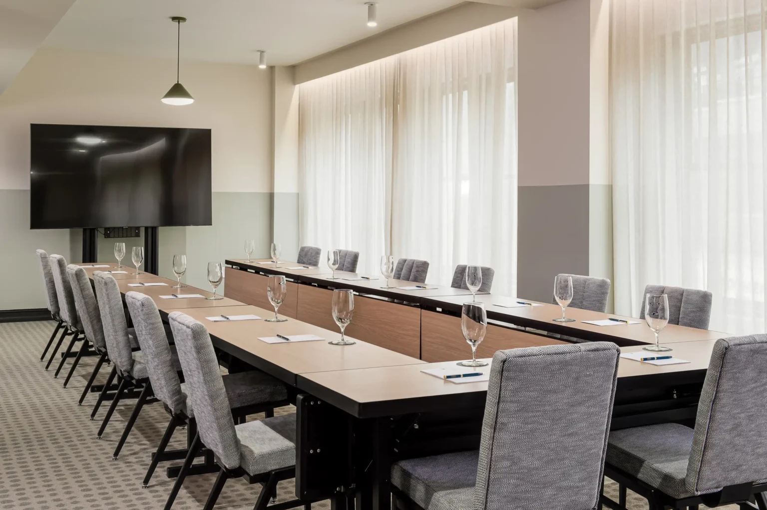 the flat iron hotel's conference room with tv view