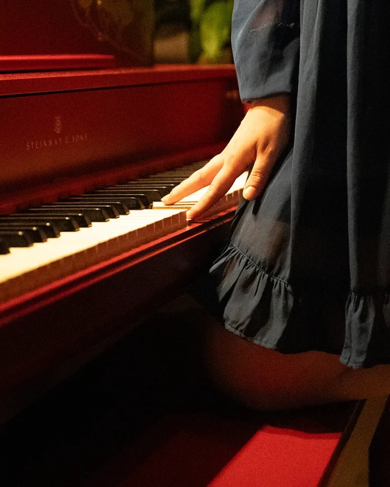 a woman plays a piano