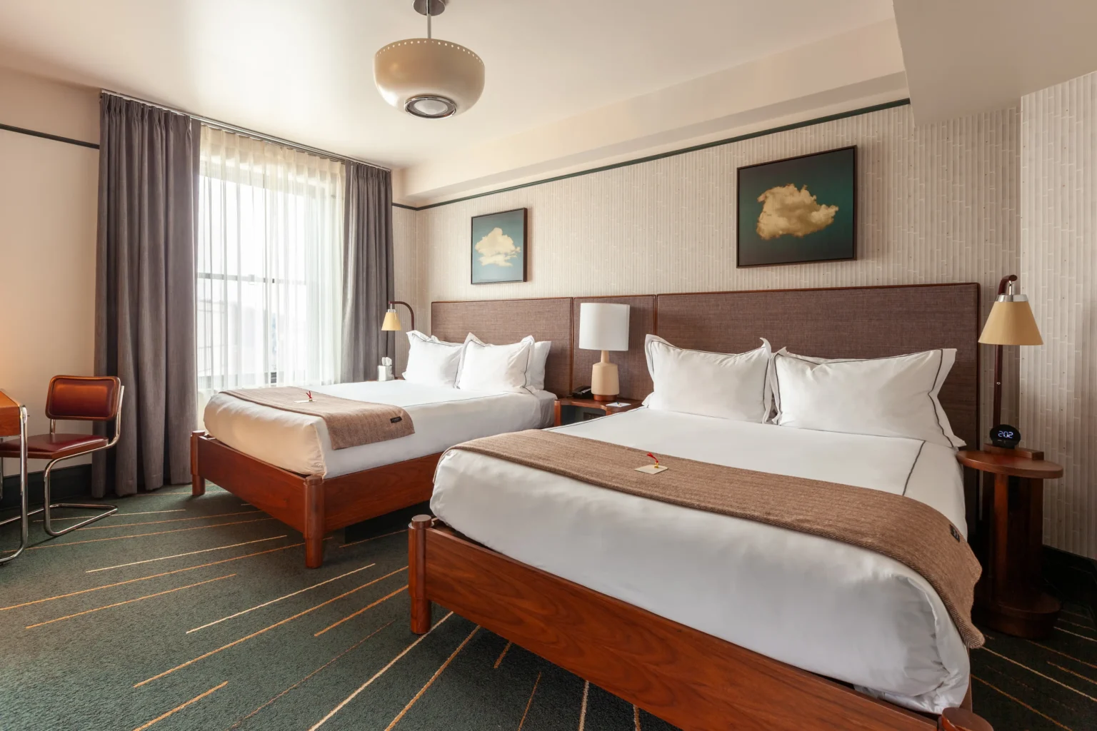 beds and furnishings in the double queen room at the flat iron hotel