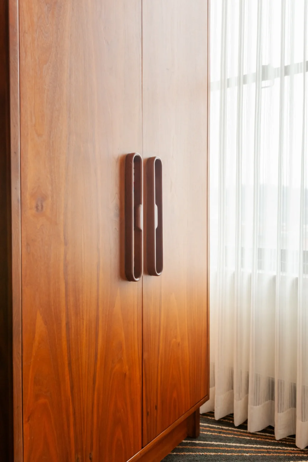 armoire in a queen suite at the flat iron hotel