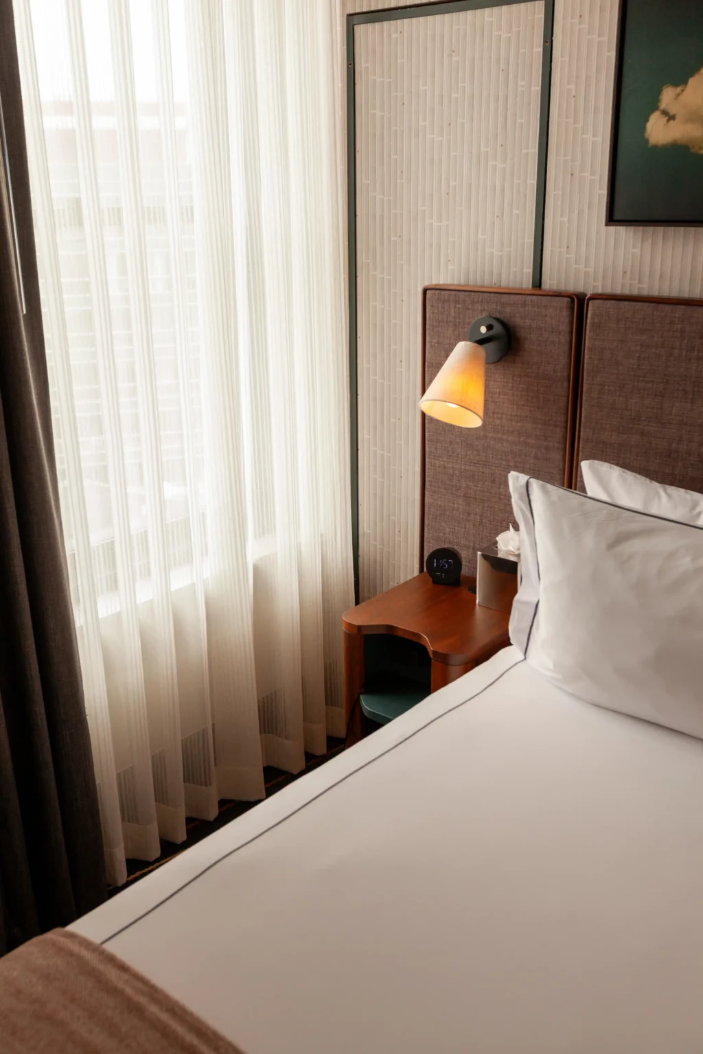 Queen Suite at the flat iron hotel, showing the night stand and part of the bed