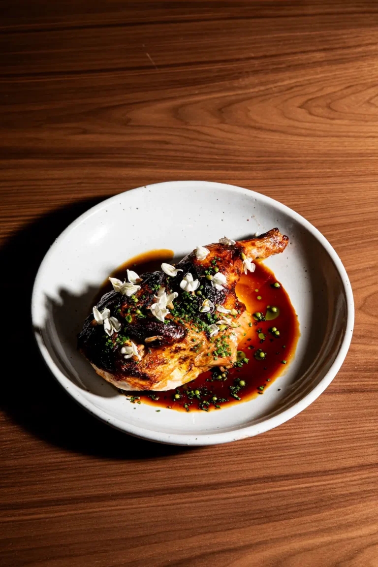 Roasted half chicken with floral garnish