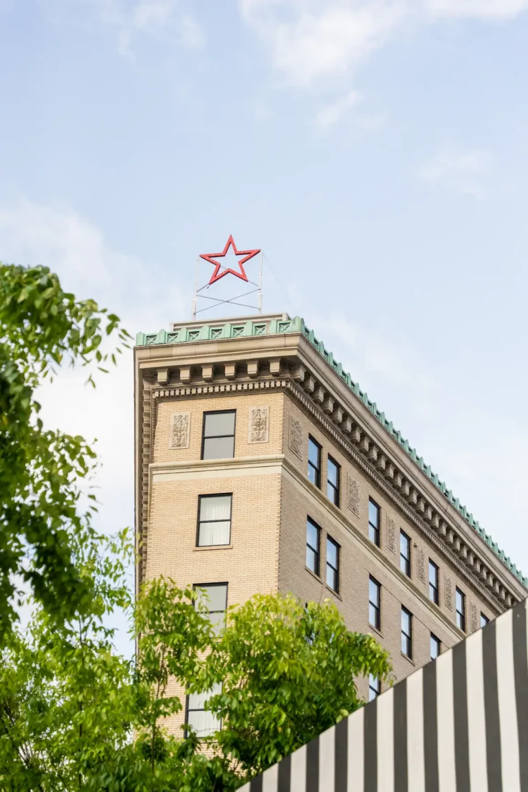 The peak of the Flat Iron Hotel, with a red star attached