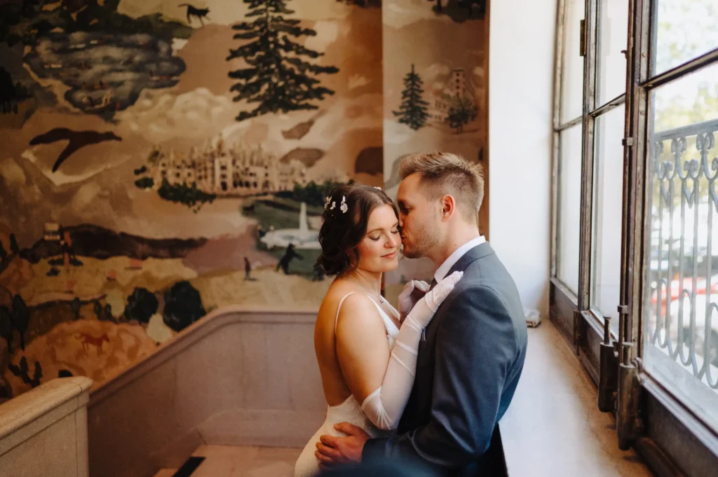 a newlywed couple embraces on the stairwell of the Flat Iron Hotel