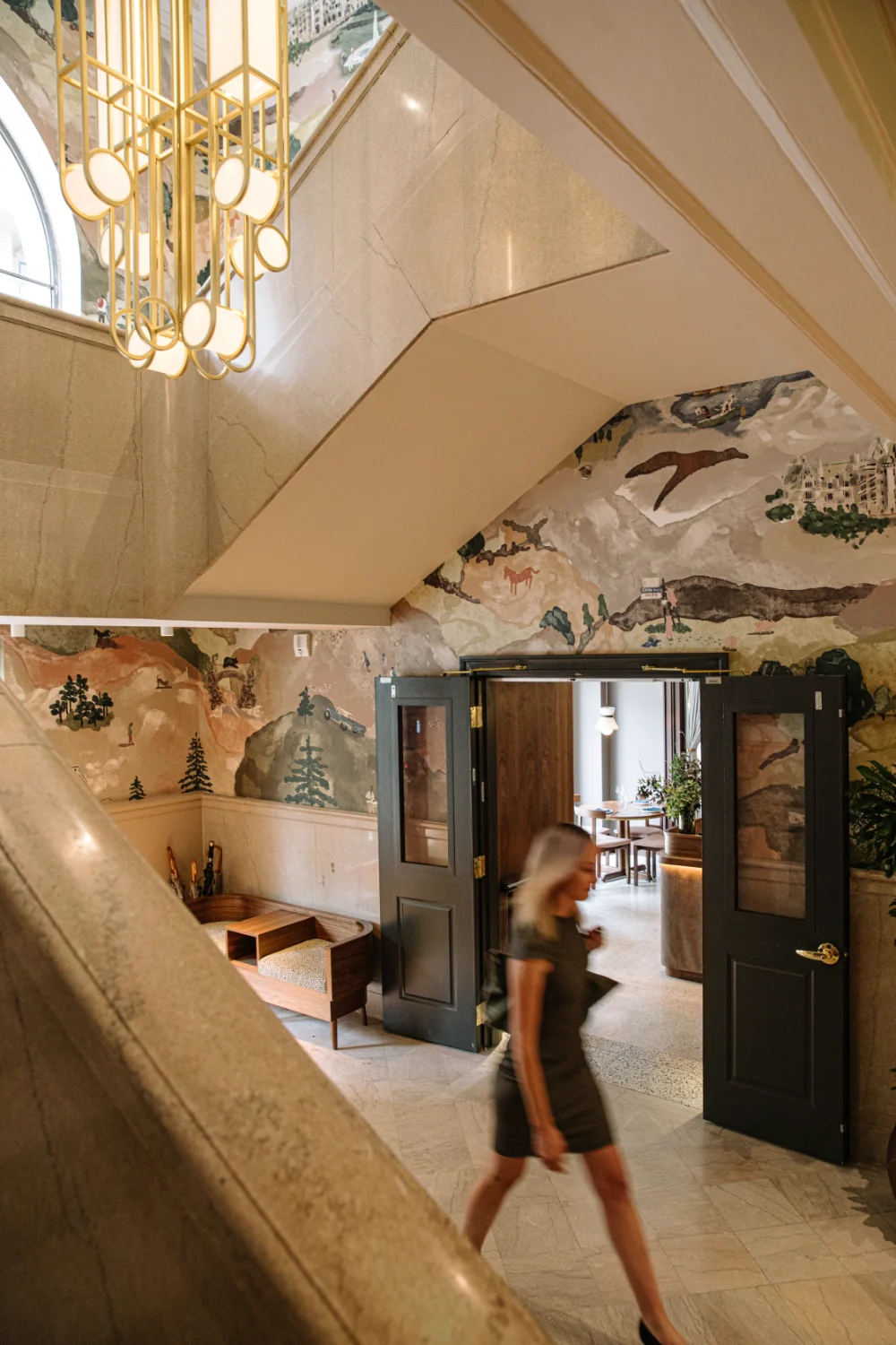 a woman walking into the Flat Iron Hotel lobby