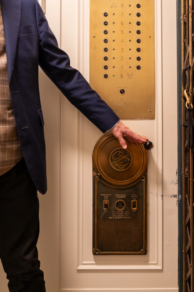 an attendant operates a restored historic elevator